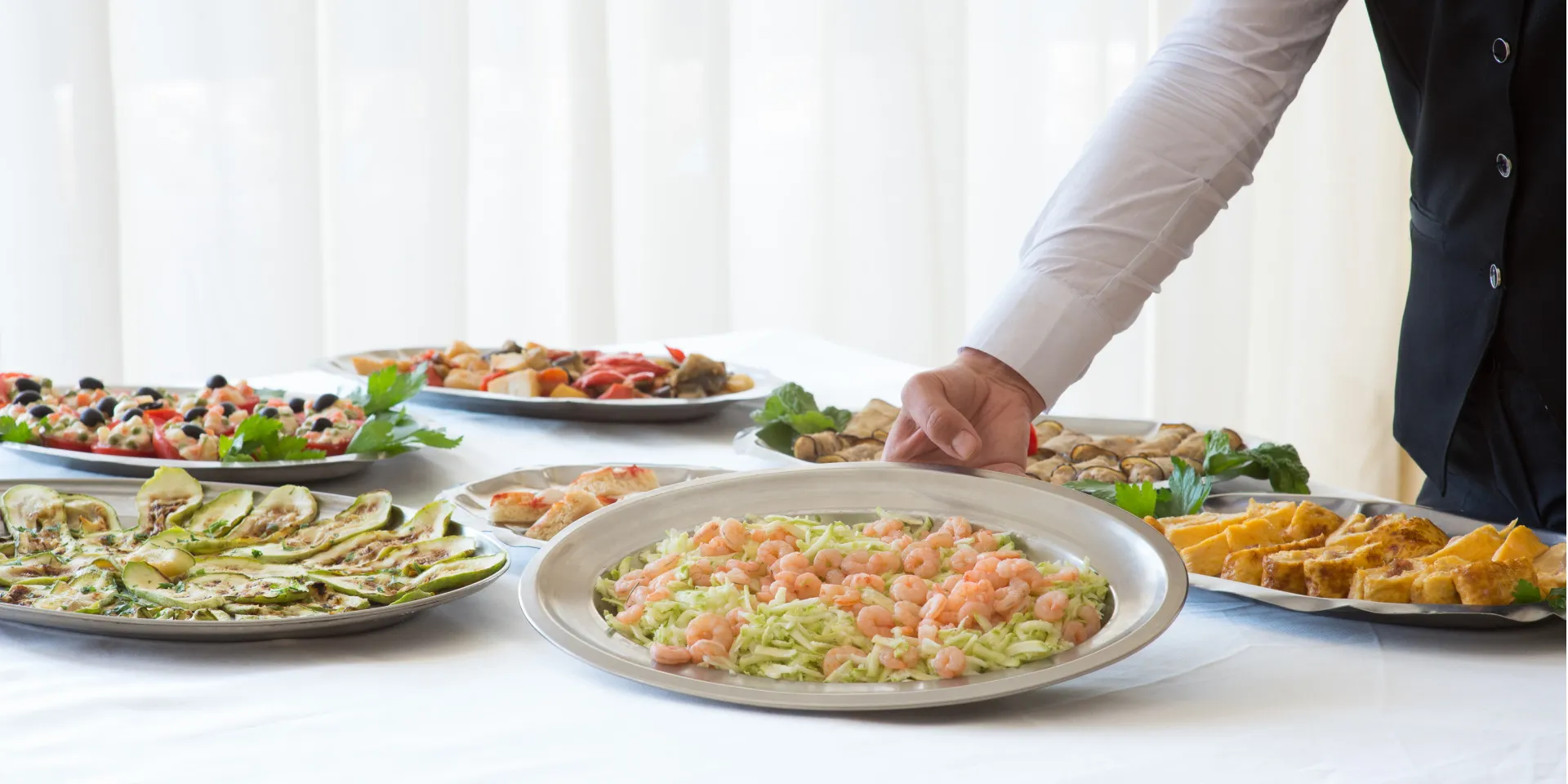 Buffet di antipasti con gamberetti, verdure grigliate e stuzzichini