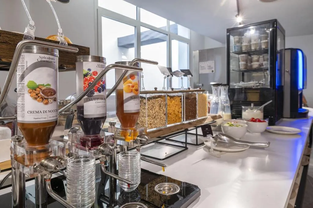 Buffet della colazione con dispenser di creme, cereali e marmellate